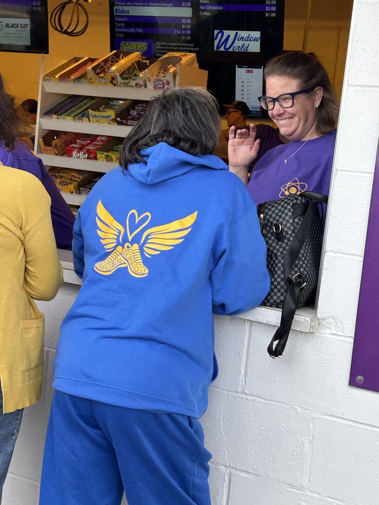 Central DeWitt and Walhert track & field teams wearing shirts in honor of Trisha Brookins