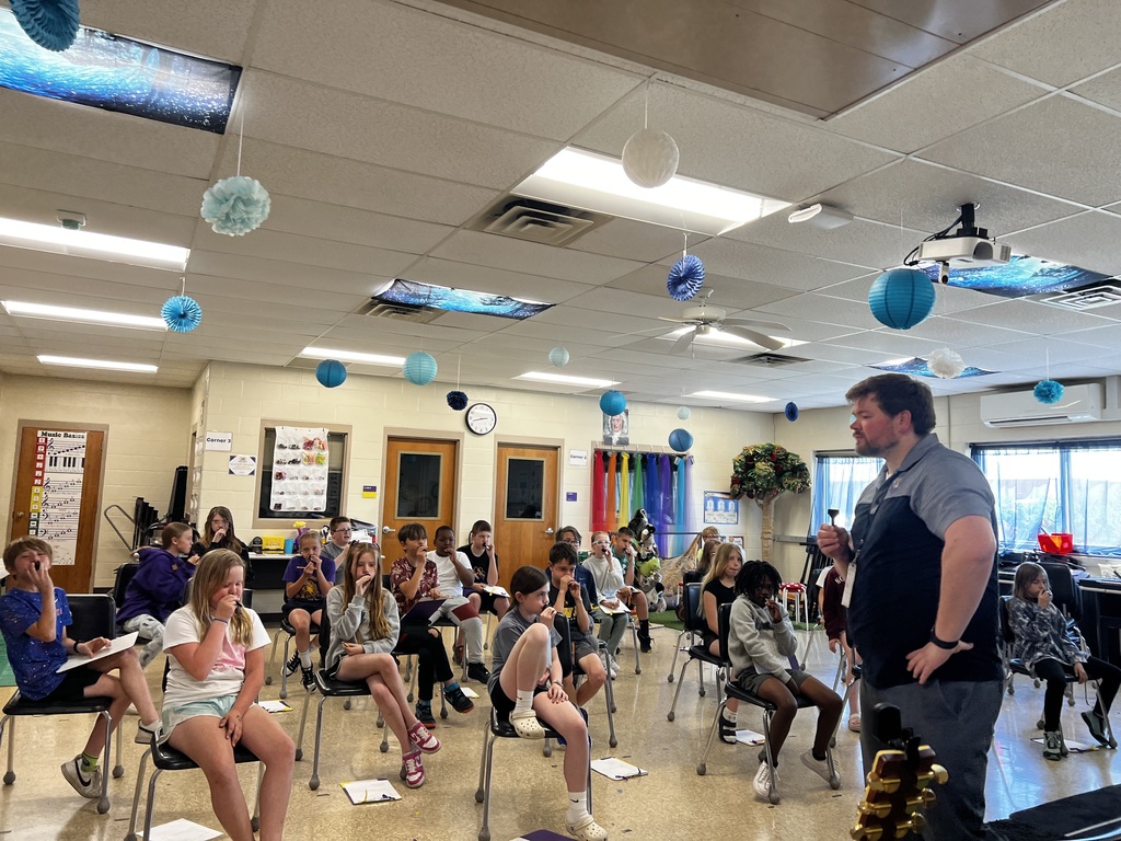 4th grader trying out musical instruments