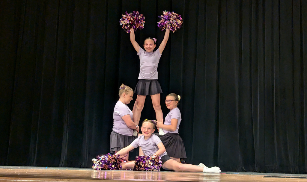 Students in a cheerleading pyramid formation