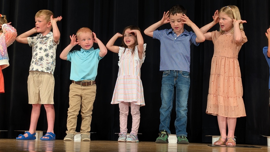 Preschoolers performing songs at their graduation ceremony