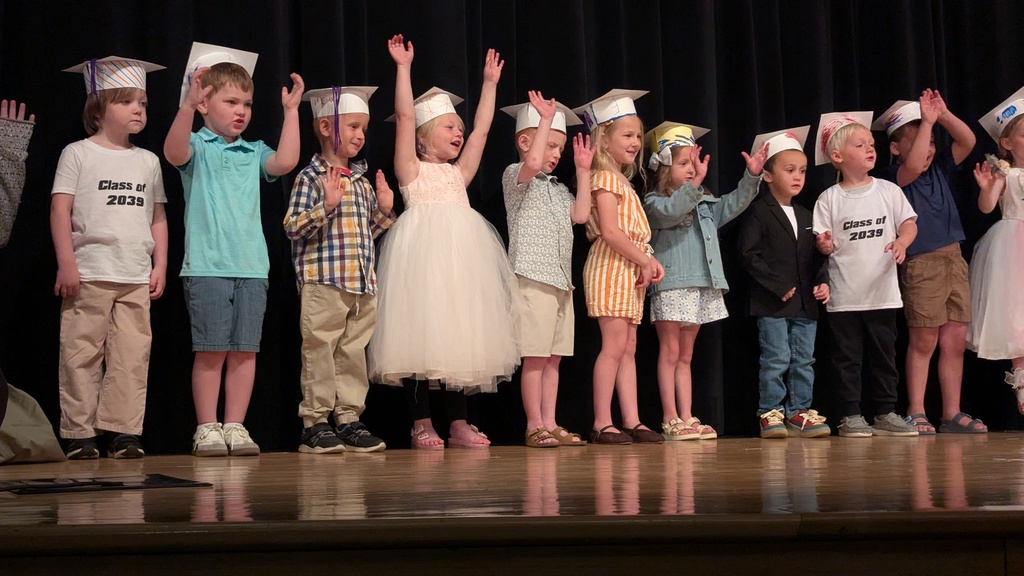 Preschoolers performing songs at their graduation ceremony