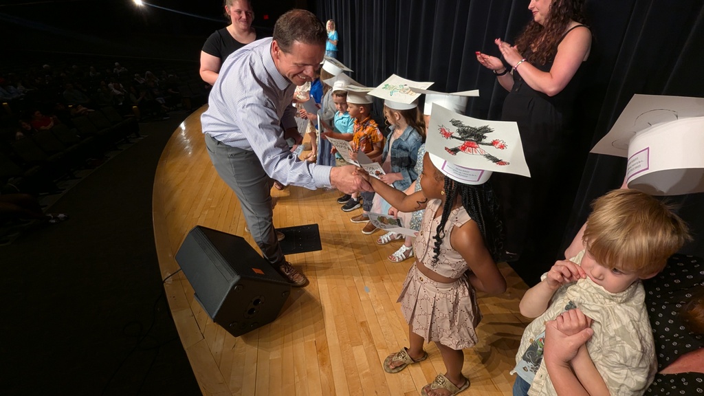Preschooler receiving his diploma