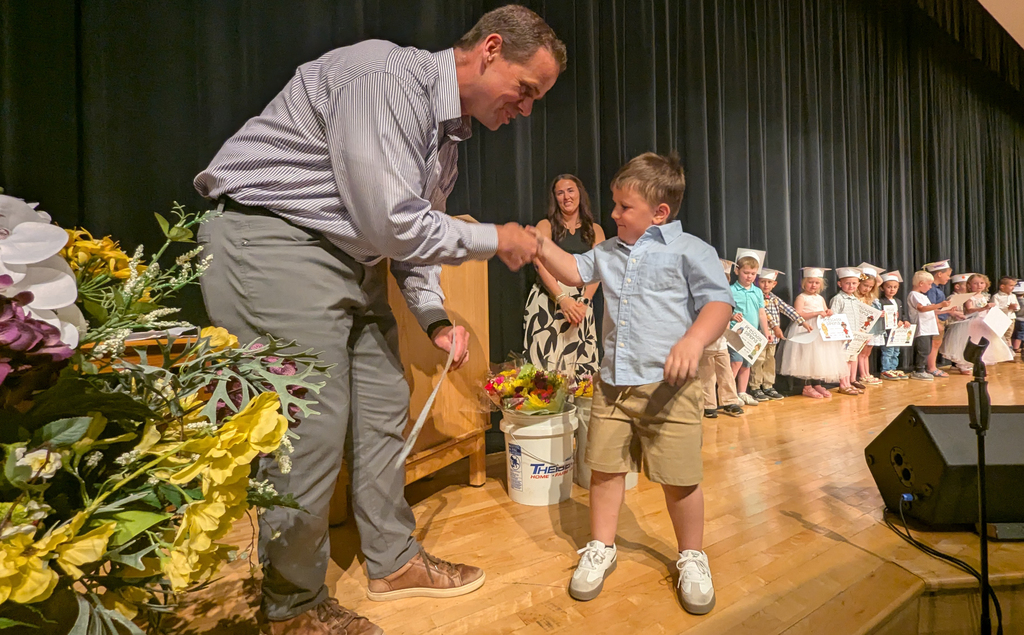 Preschooler receiving his diploma