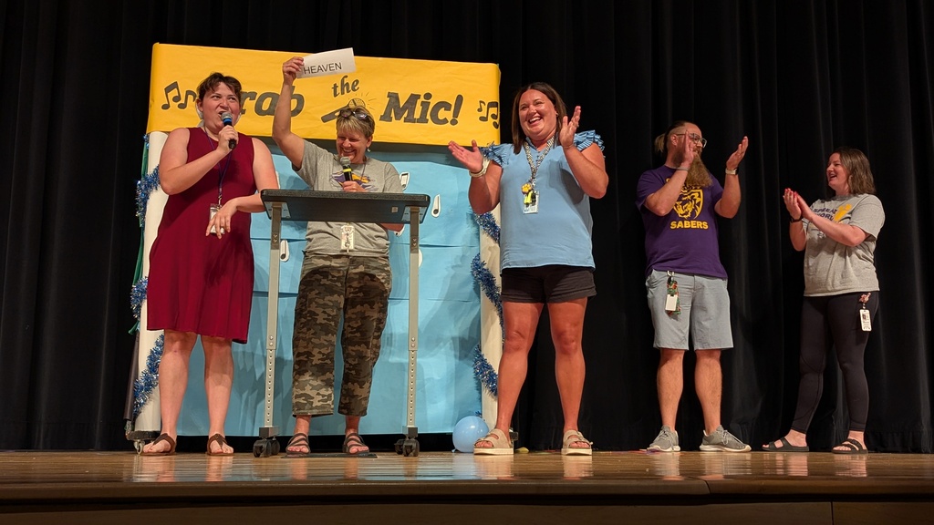 Staff members competing in "Grab the Mic"