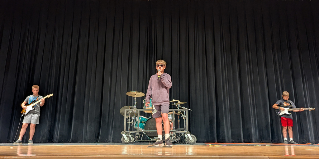 Students in a band performing a song by Journey