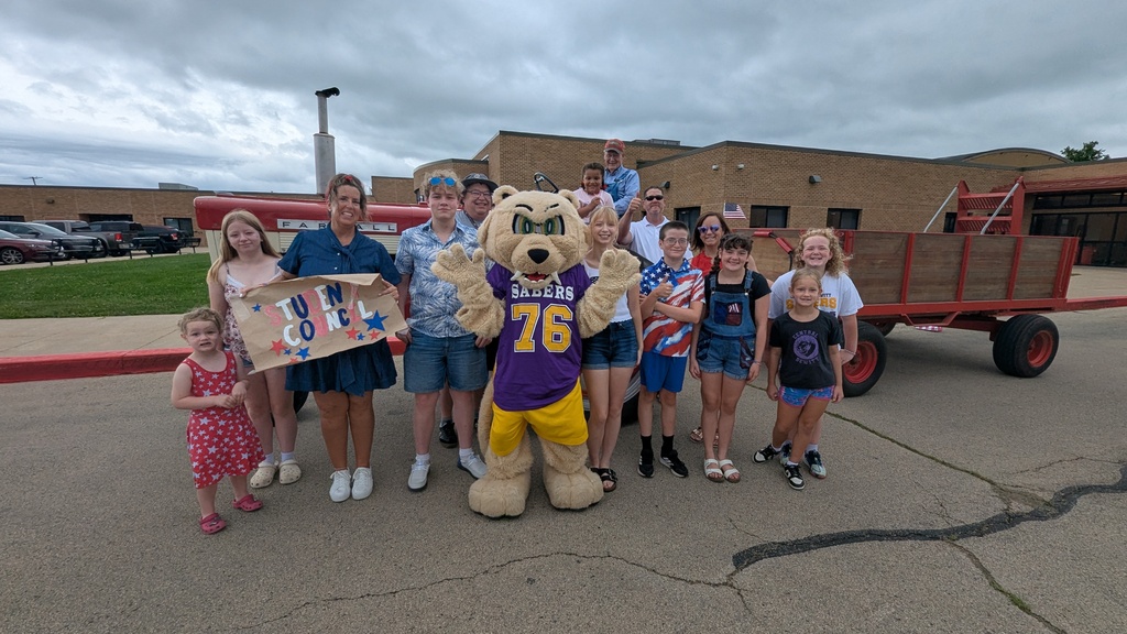 Central DeWitt students, administrators, school board members and Slash participating in the 4th of July parade