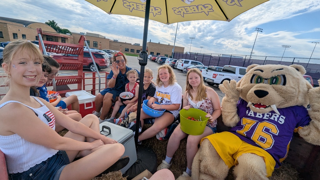 Central DeWitt students, administrators, school board members and Slash participating in the 4th of July parade