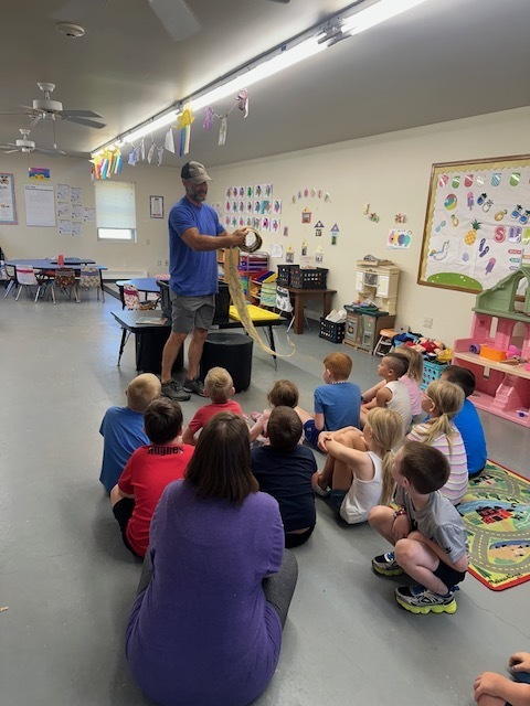 Clinton County Conservation showing students a snake