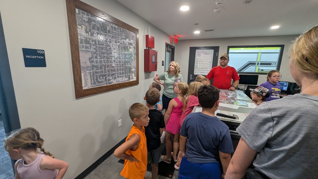 Students looking at a map of DeWitt that helps firefighters see where they need to go in an emergency