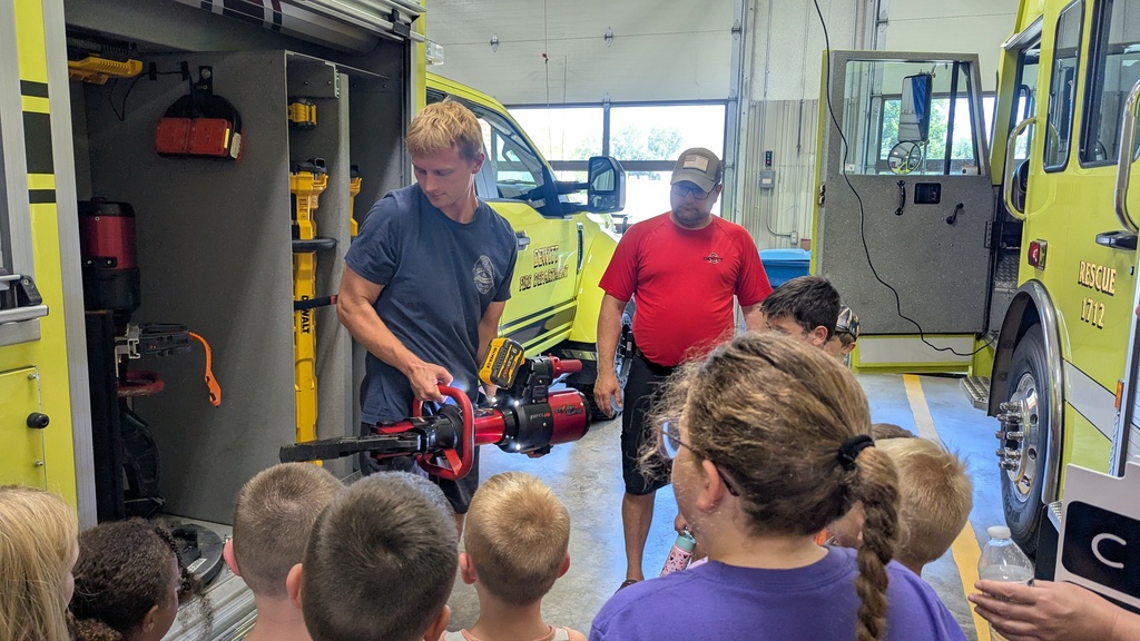 Kyle Fox demonstrating a piece of equipment used to cut