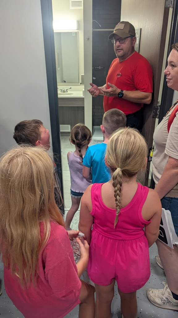 Andy Johnston showing the students where the firefighters shower