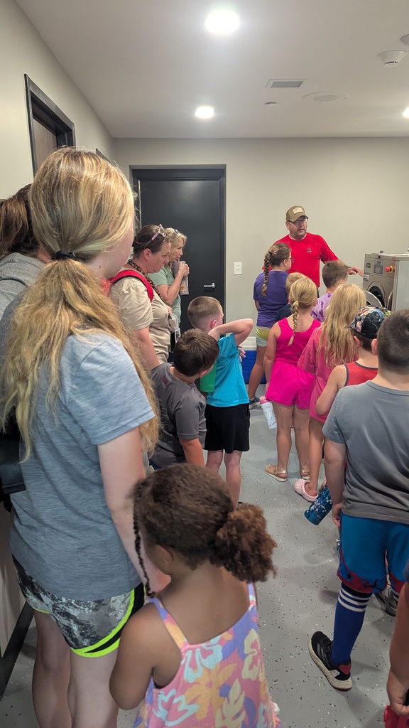 Andy Johnston showing the students where they wash their uniforms