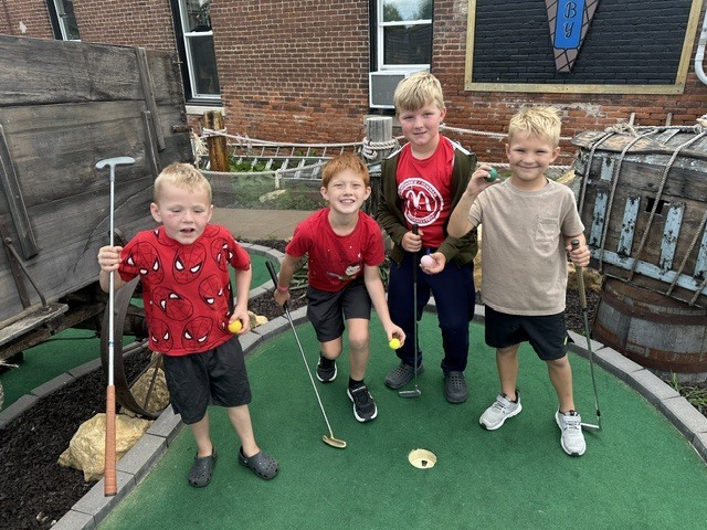 Sabers cubs playing miniature golf