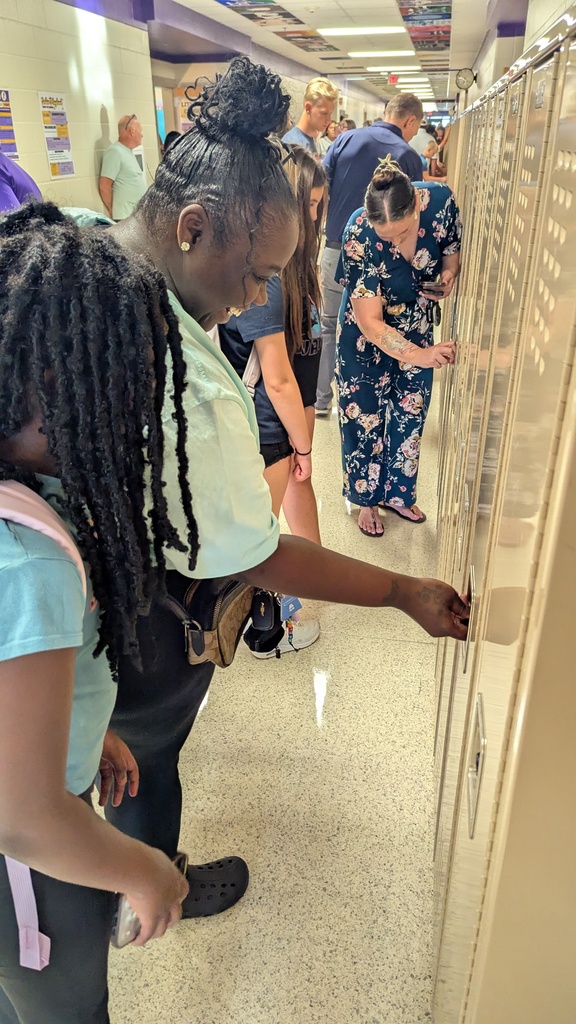 Parents and students trying locker combinations