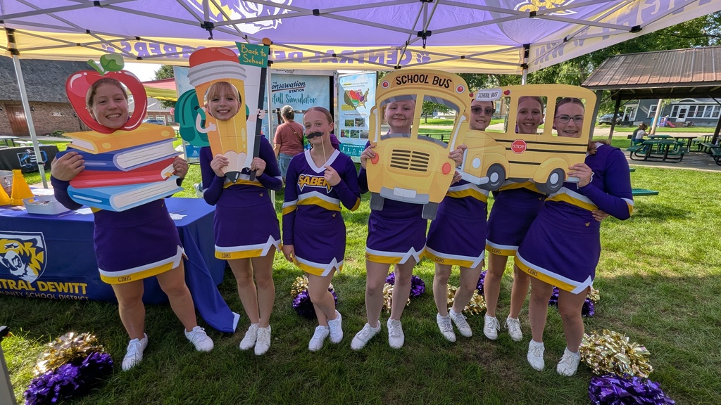 Cheerleaders posing with photo props