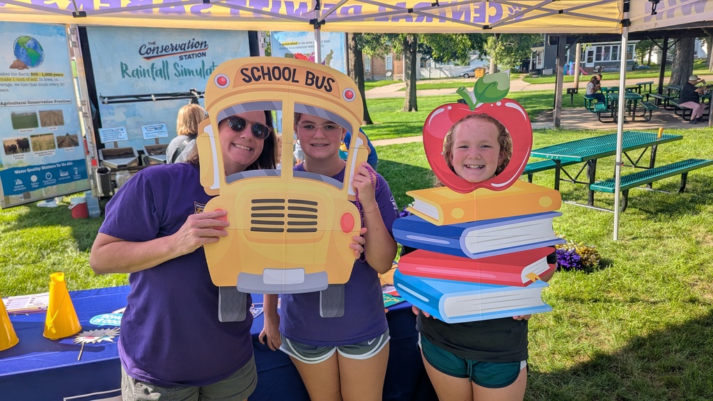 Superintendent Dr. Mishler and her daughters posing with back-to-school photo props