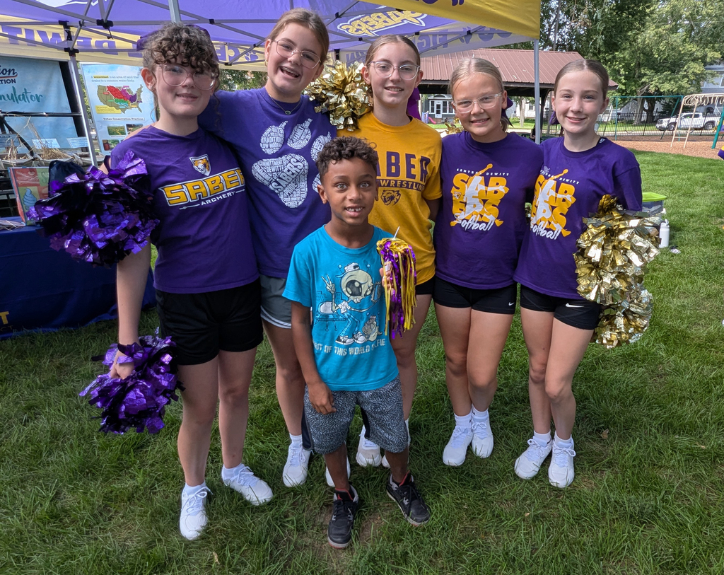 Central DeWitt cheerleaders and a young Saber at the farmers market