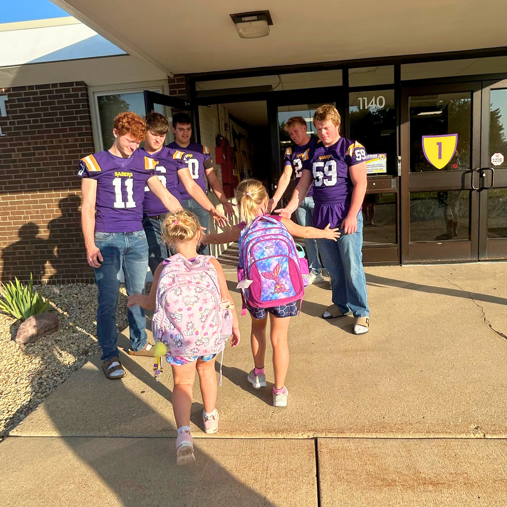 Saber Football players greeting Ekstrand students