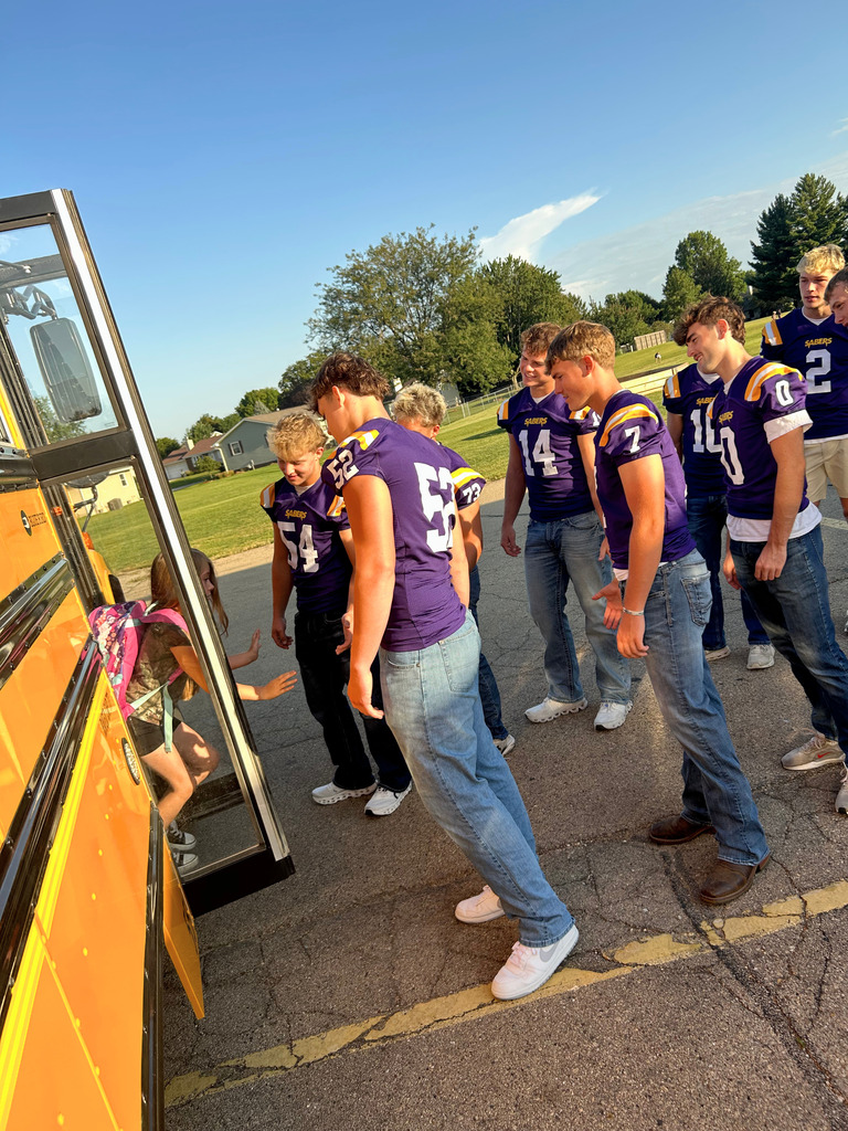 Saber Football players greeting Ekstrand students