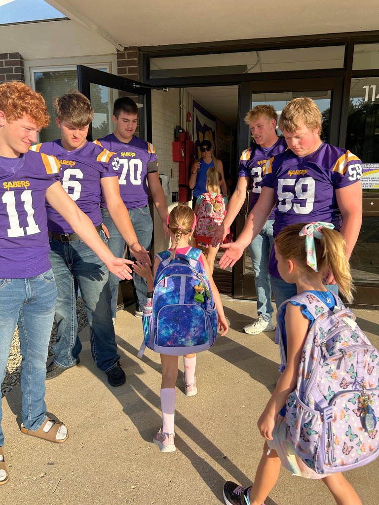 Saber Football players greeting Ekstrand students