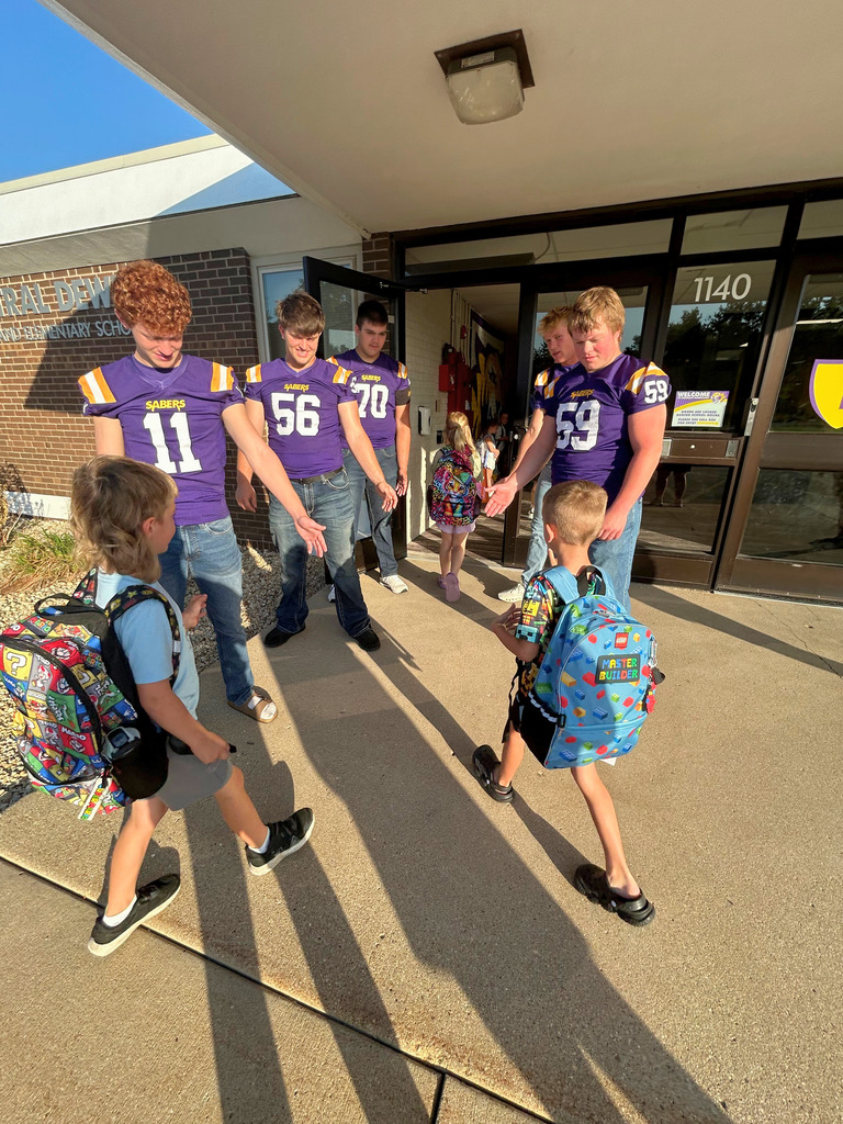 Saber Football players greeting Ekstrand students