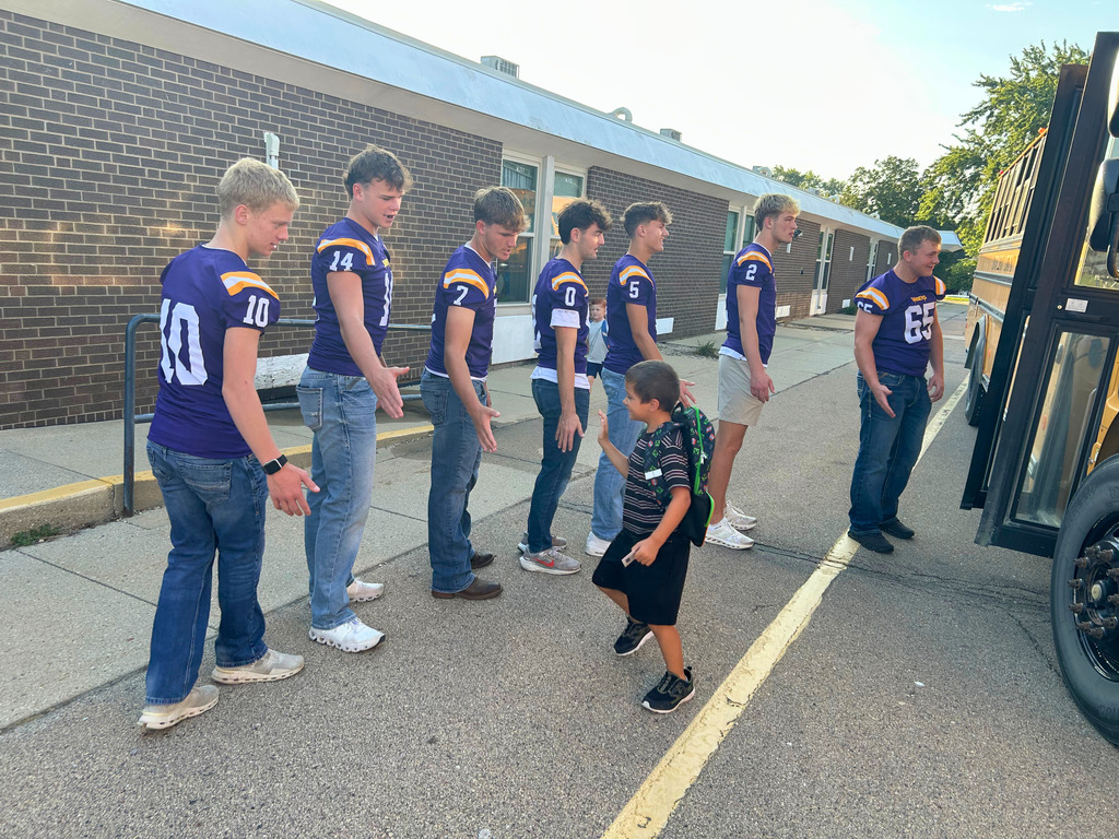 Saber Football players greeting Ekstrand students