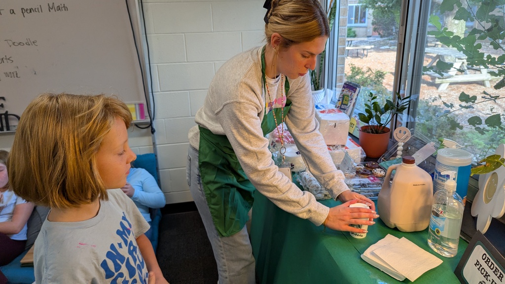 Ms. Pickup serving "lattes" (chocolate milk) to students