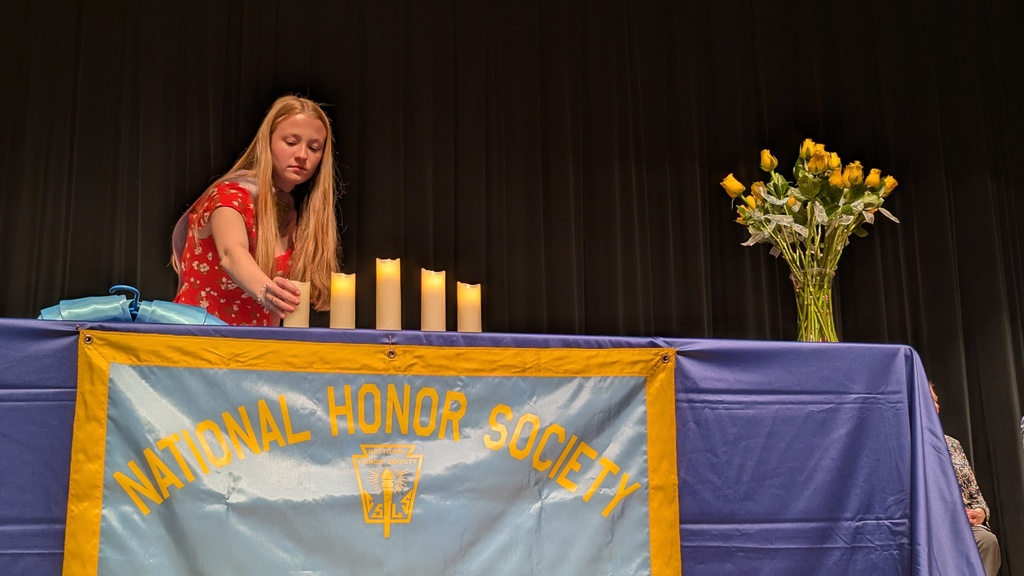 An officer lights a candle during the ceremony
