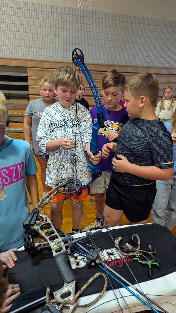 Students exploring different bows used in archery