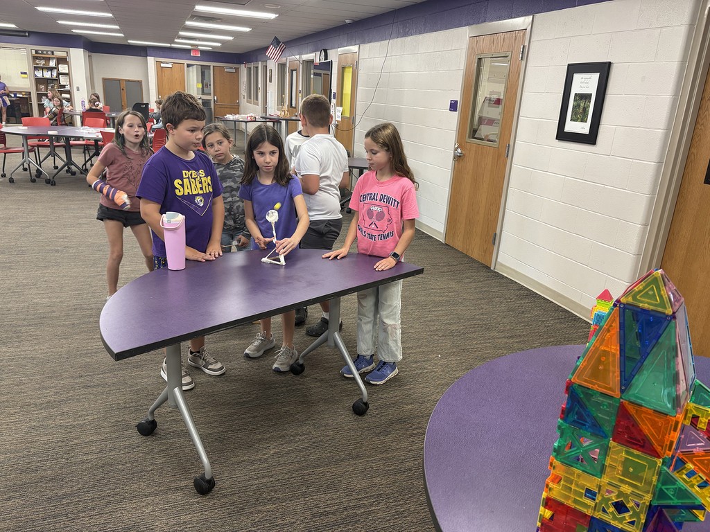 Students trying out the catapults they built