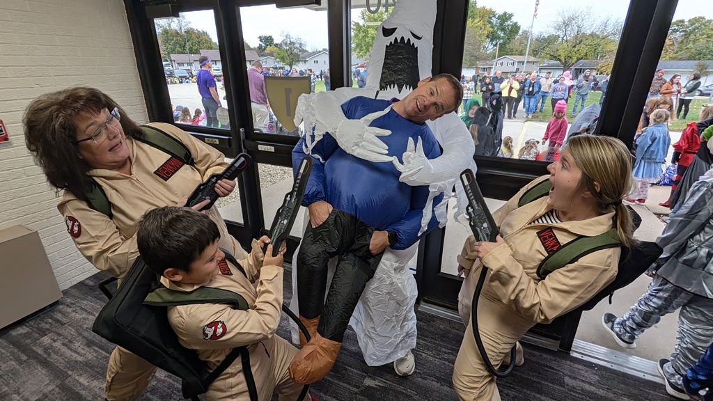 Principal Mike Miller dressed as ghost while Secretary Angie Herington, Health Associate Kenzie Riedesel and a student are dressed as Ghostbusters