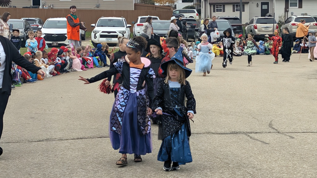 First graders dressed as witches showing off their Halloween costumes in the parade