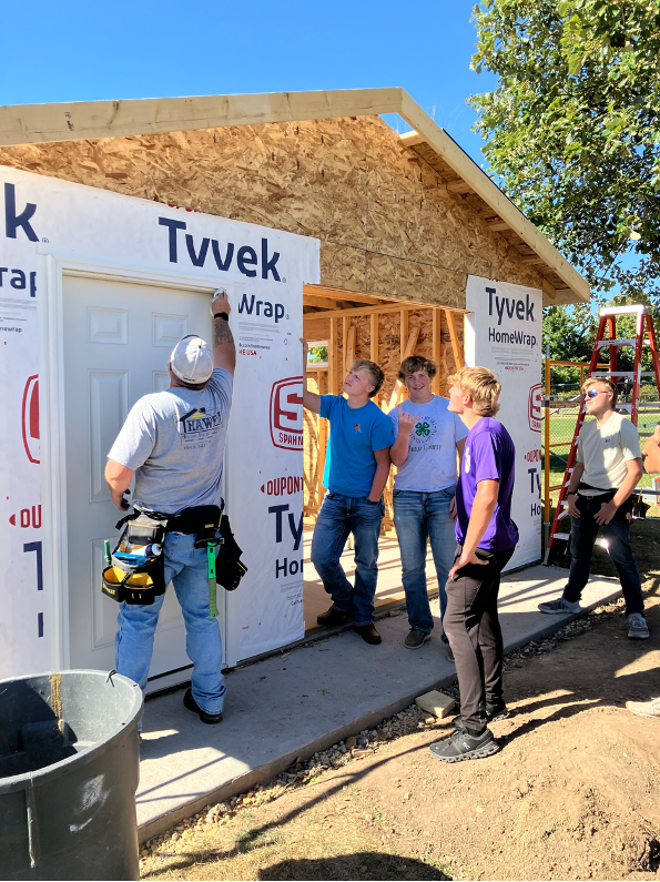 Students learning to install doors