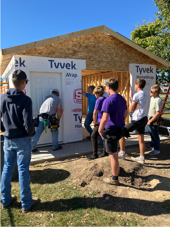 Students learning to install doors