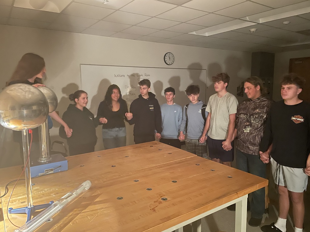 Students interacting with Physics equipment