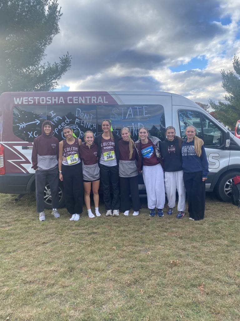 Cross Country Athletes standing in front of the school van