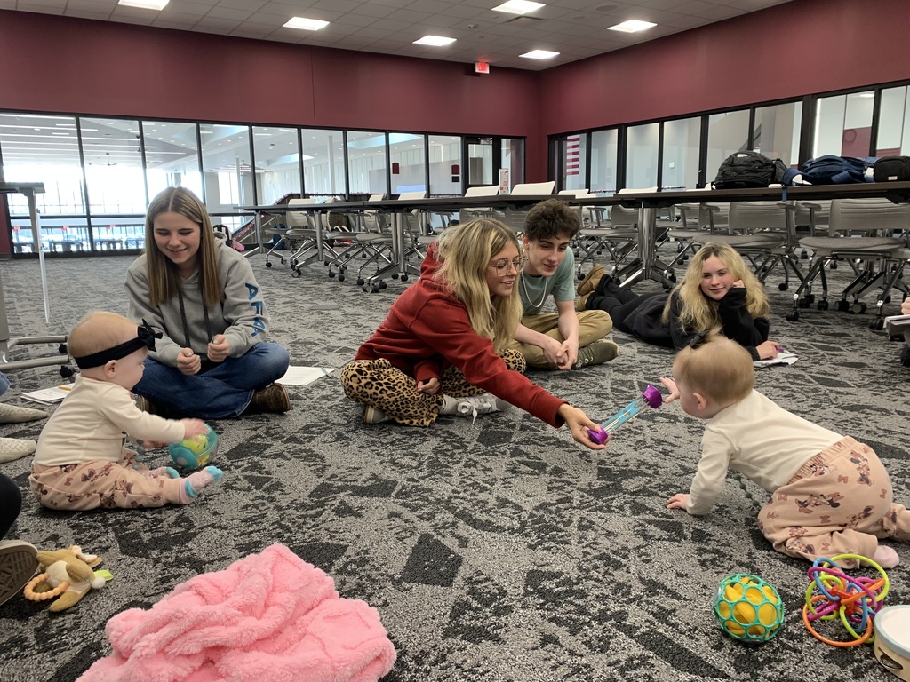 Students interacting with a baby