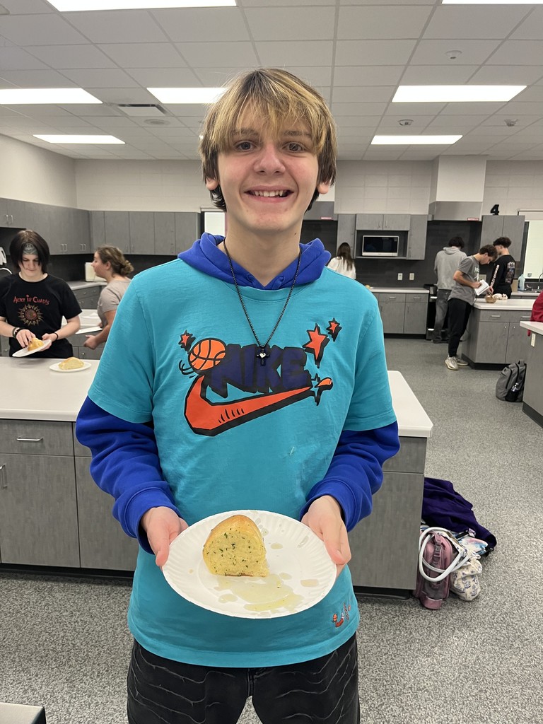 Student holding a plate of food