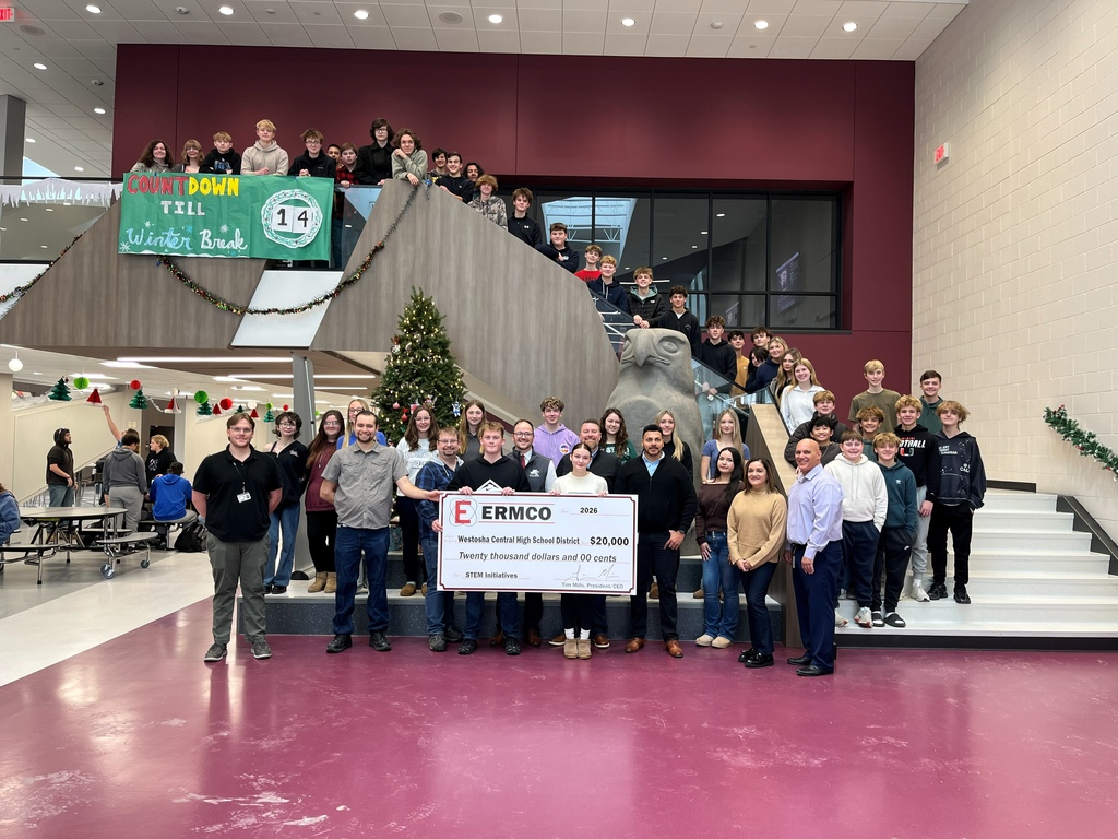Students posing with donation check