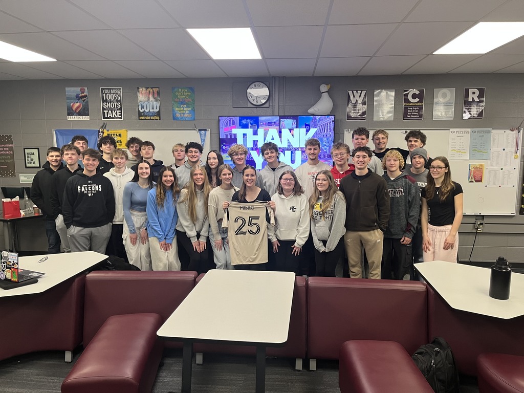 Students standing with guest speaker