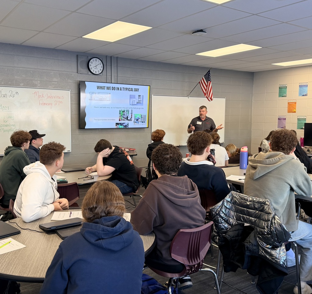 Man speaking to a class of students
