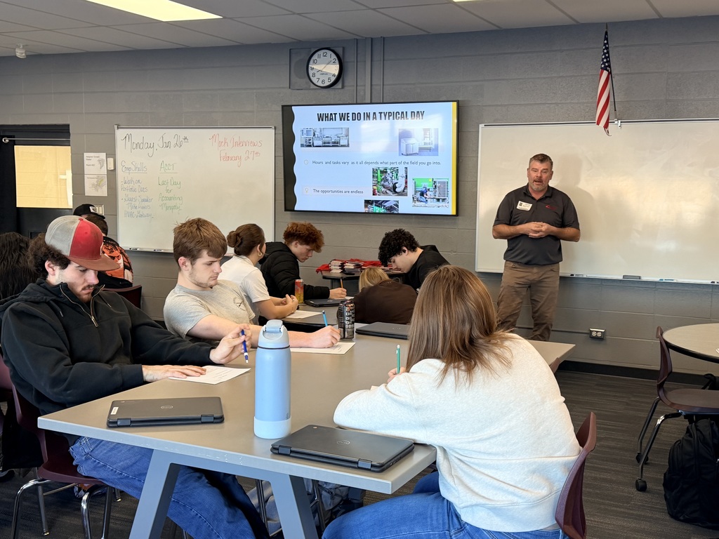 Man speaking to a class of students