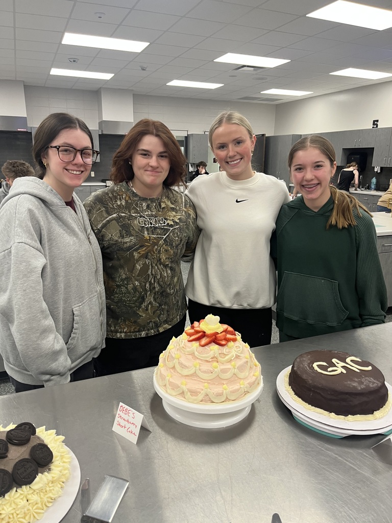 Students posing with cake