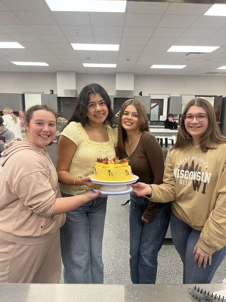Students posing with cake