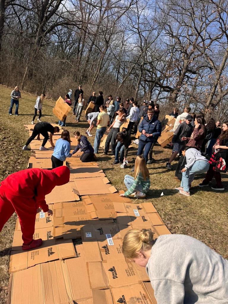 Students laying cardboard