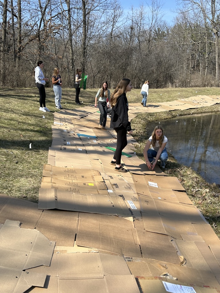 Students laying cardboard