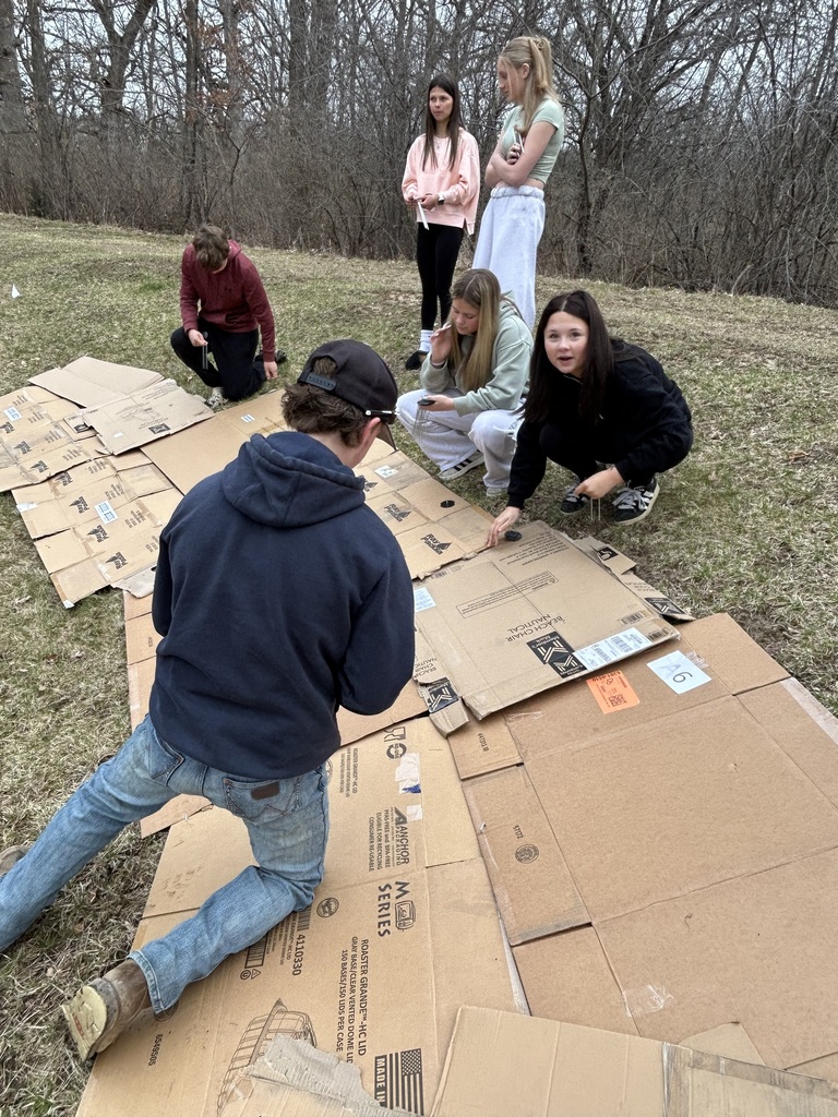 Students laying cardboard