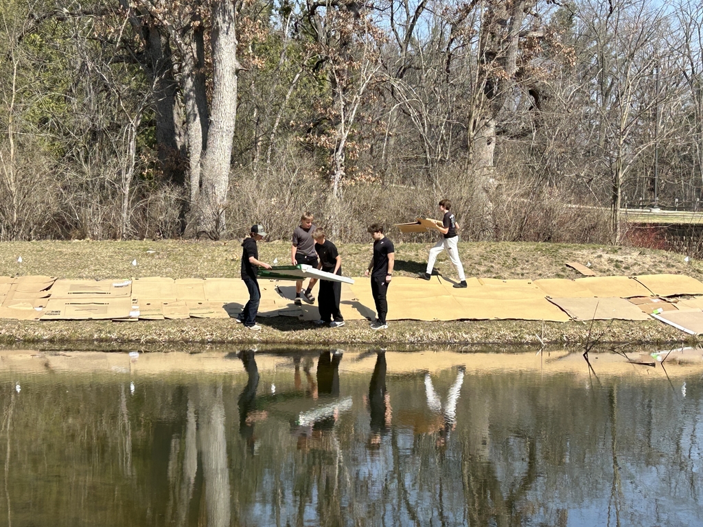 Students laying cardboard