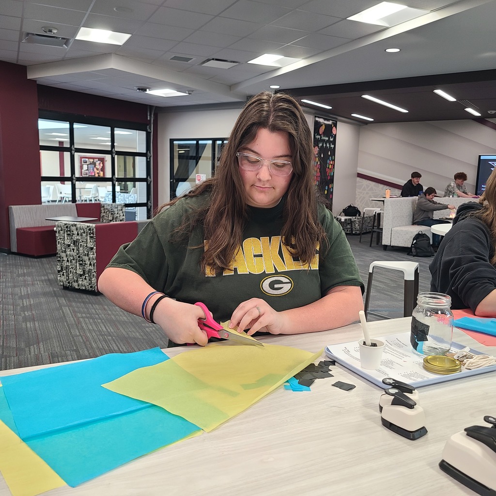 Student cutting paper