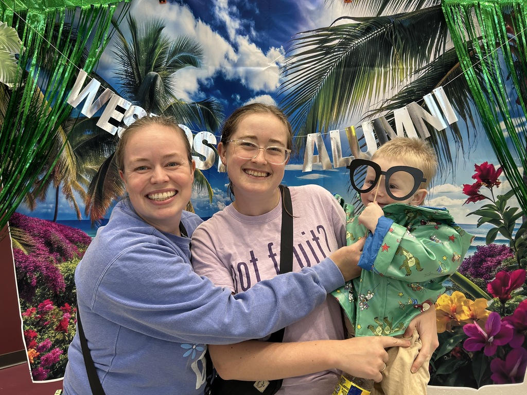 Three people smiling